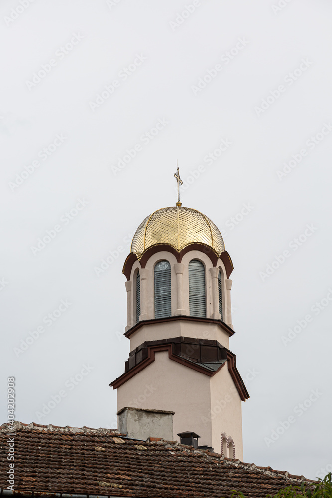 Church bell tower with golden cover