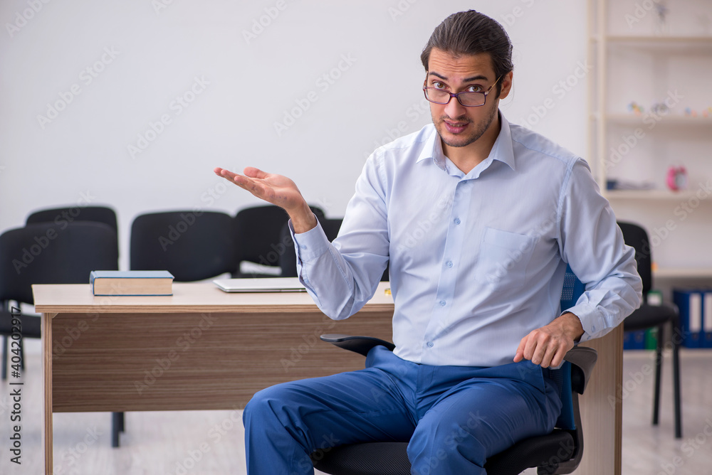 Young male boss giving seminar in the office during pandemic Young male boss giving seminar in the office during pandemic