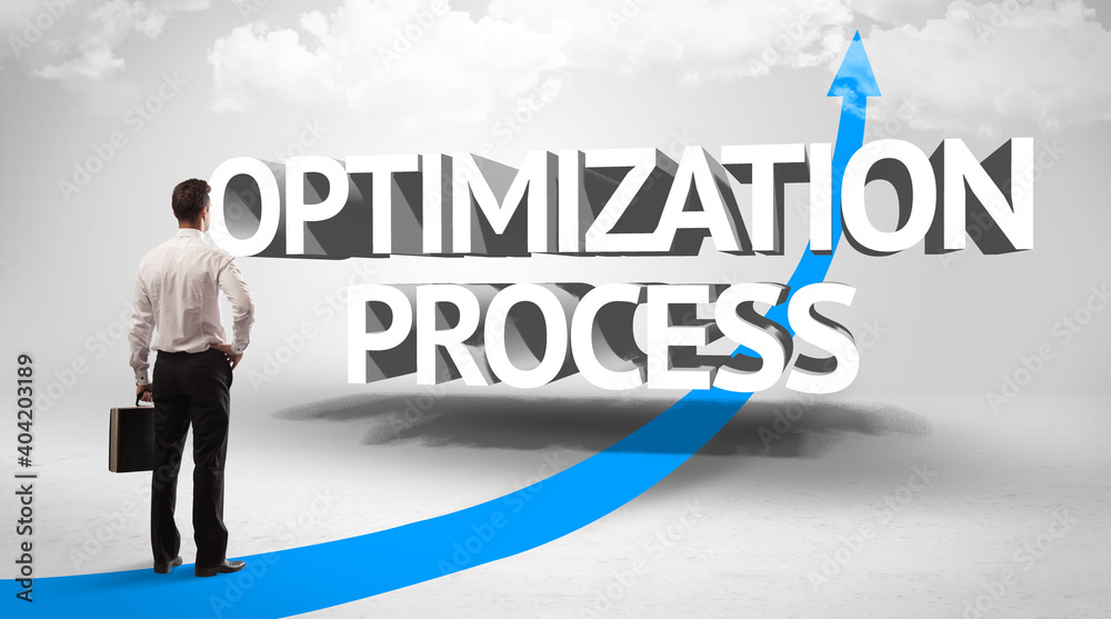 Rear view of a businessman standing in front of OPTIMIZATION PROCESS inscription, successful business concept Rear view of a businessman standing in front of OPTIMIZATION PROCESS inscription, successful business concept