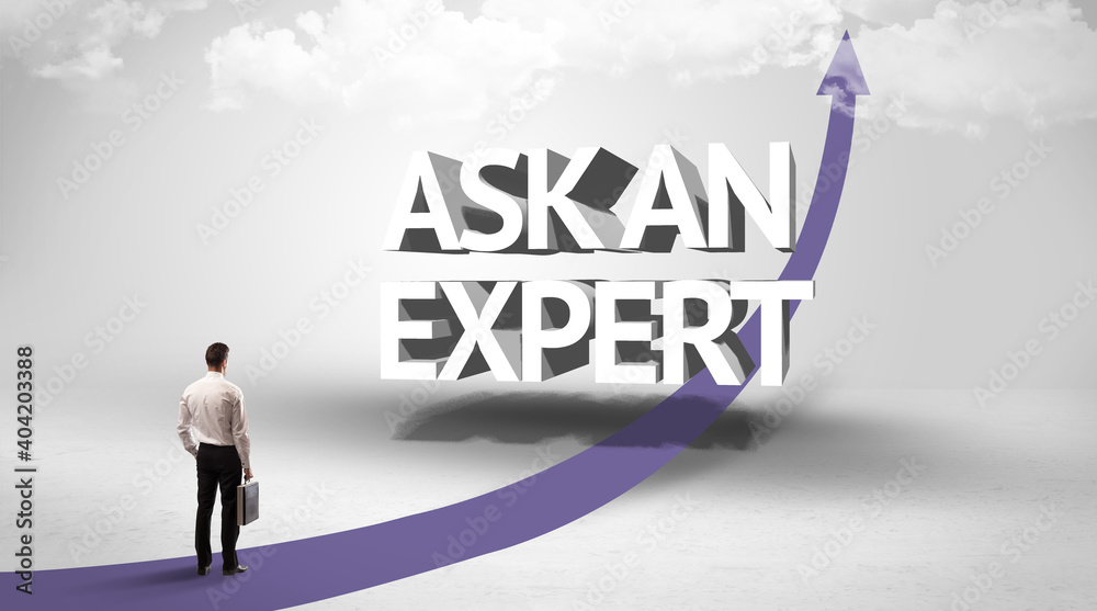 Rear view of a businessman standing in front of ASK AN EXPERT inscription, successful business concept Rear view of a businessman standing in front of ASK AN EXPERT inscription, successful business concept