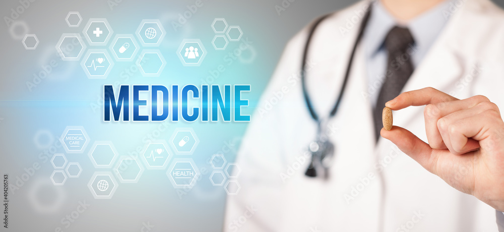 Close-up of a doctor giving you a pill with MEDICINE inscription, medical concept Close-up of a doctor giving you a pill with MEDICINE inscription, medical concept
