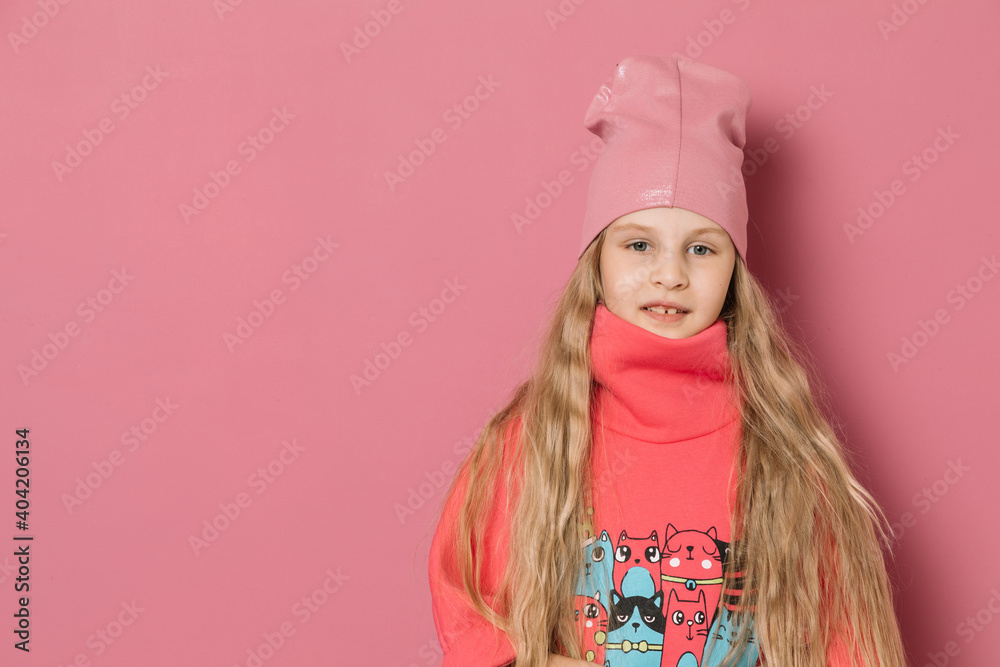 Little girl in pink clothes and a medical mask on a pink background Little girl in pink clothes and a medical mask on a pink background
