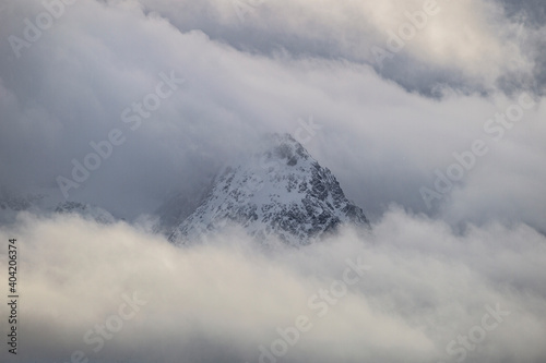 Mountain peaks through the clouds - arctic Norway