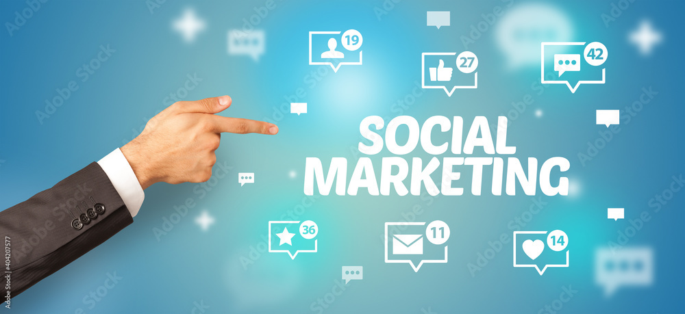 Close-Up of cropped hand pointing at SOCIAL MARKETING inscription, social networking concept Close-Up of cropped hand pointing at SOCIAL MARKETING inscription, social networking concept