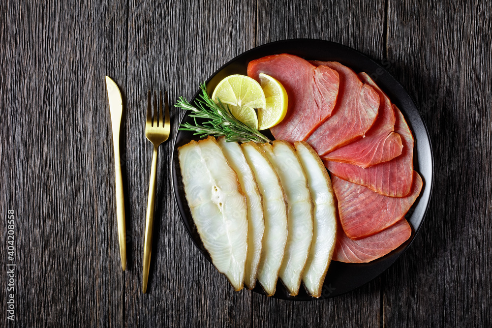 Smoked halibut and tuna slices, top view, close-up Smoked halibut and tuna slices, top view, close-up