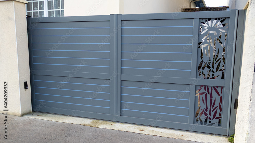 Fototapeta premium modern grey gate aluminum home portal gray door suburban house in street view