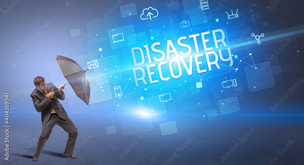 Businessman defending with umbrella from cyber attack and DISASTER RECOVERY inscription, online security concept Businessman defending with umbrella from cyber attack and DISASTER RECOVERY inscription, online security concept