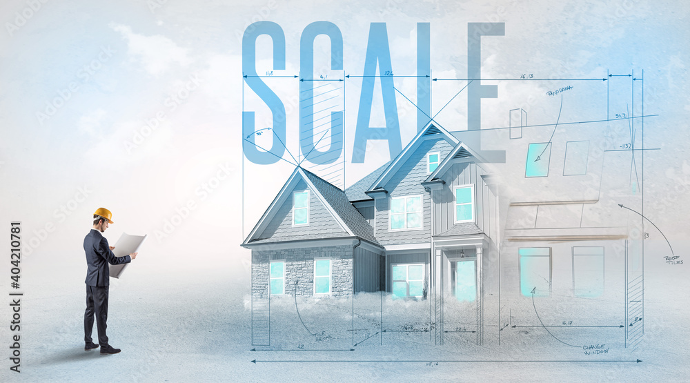 Young engineer holding blueprint with SCALE inscription, house planning concept Young engineer holding blueprint with SCALE inscription, house planning concept