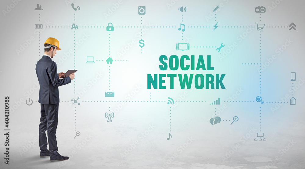 Engineer working on a new social media platform with SOCIAL NETWORK inscription concept Engineer working on a new social media platform with SOCIAL NETWORK inscription concept