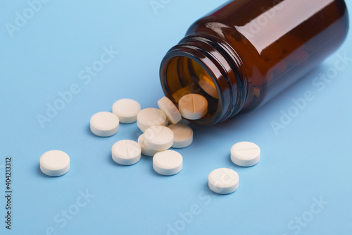 Medicine white pills and glass bottle