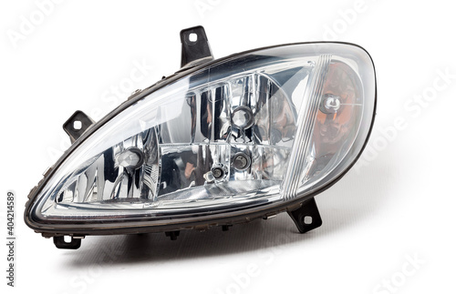 Stylish xenon headlight of a German car - optical equipment with a lamp inside on a white isolated background. Spare part for auto repair in a car workshop.