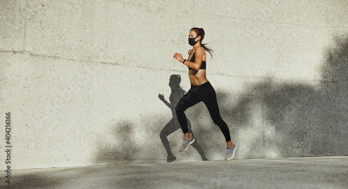 Woman on a morning run with face mask