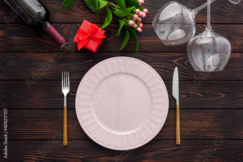 Valentine's day table setting with plate, wine and glasses