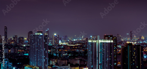 Cityscape of modern building in the night. Modern architecture office building. Skyscraper with beautiful evening sky. Business and financial center building. Apartment in the city with night light. © Artinun
