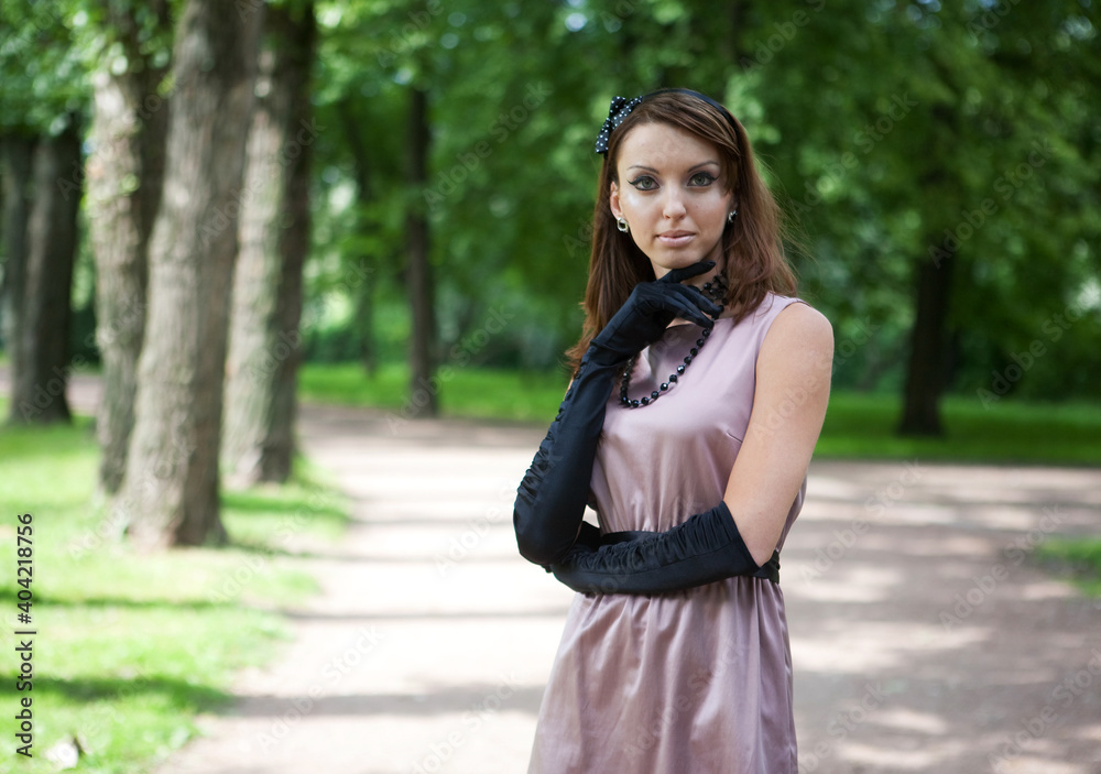 Portrait of a beautiful woman wearing vinatge outfit in summer park Portrait of a beautiful woman wearing vinatge outfit in summer park