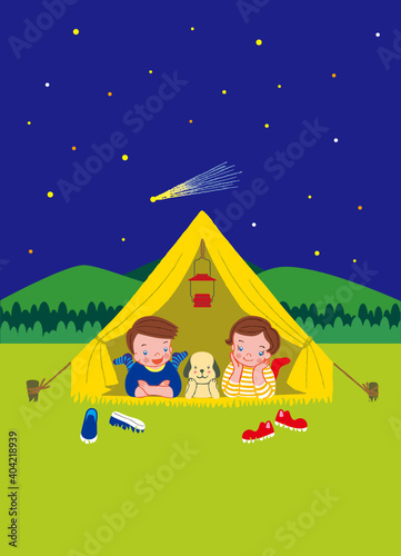 A boy, a girl, and a dog are looking at the stars from a tent.