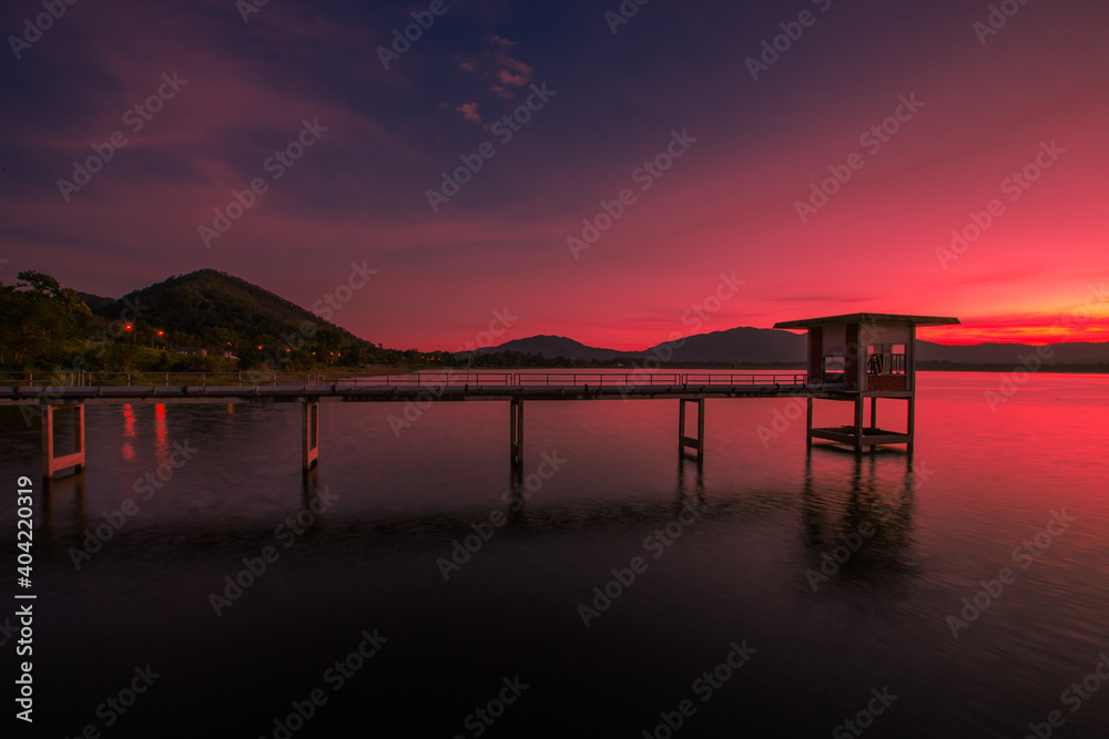 Fototapeta premium The background of the bridge stretches into the sea, with twilight light in the morning, beautiful colors, sky wallpaper and refreshing surroundings.