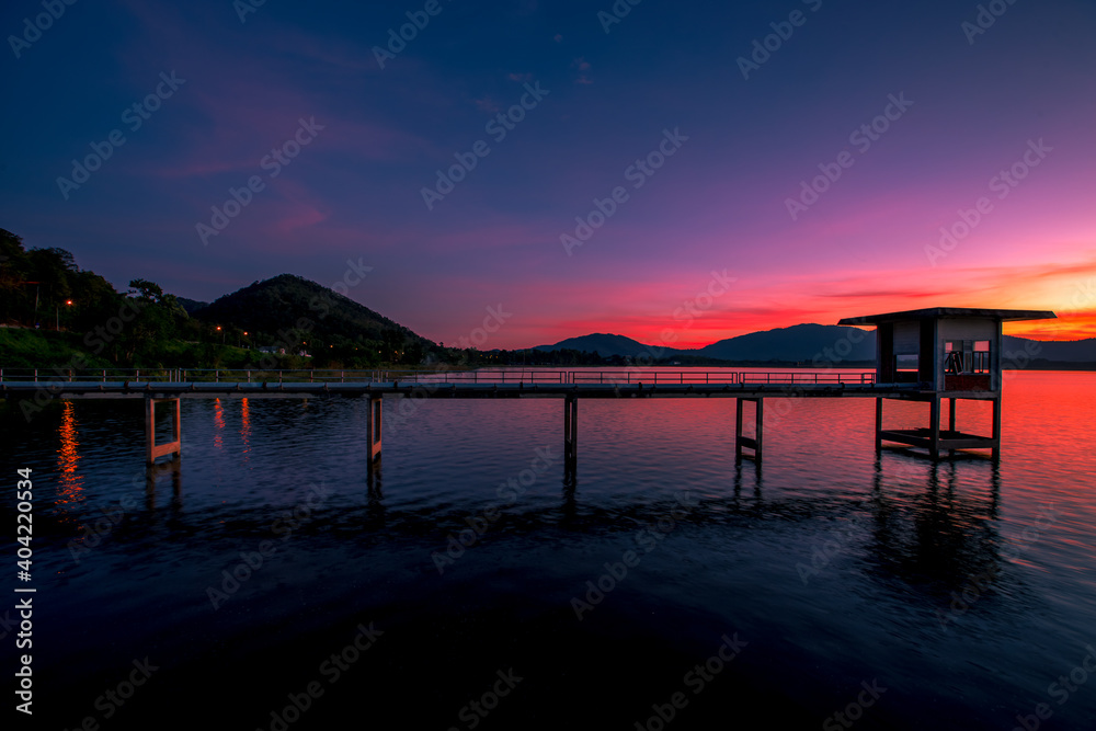 The background of the bridge stretches into the sea, with twilight light in the morning, beautiful colors, sky wallpaper and refreshing surroundings.