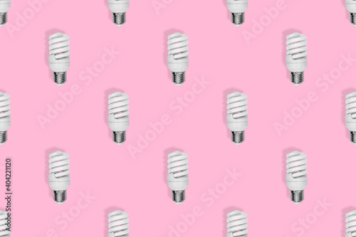 Light bulb seamless pattern. Lighting bulbs on a pink background.