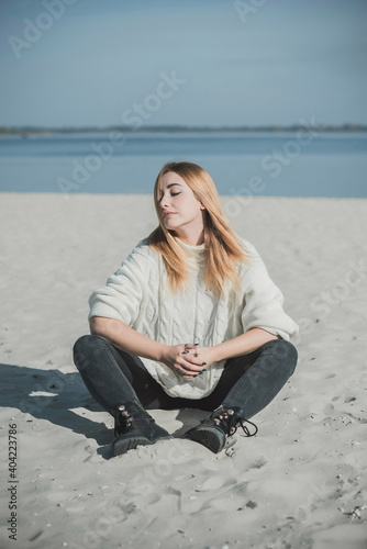 Philosophical portrait, Nice natural redhead plus size women at beach in spring time.