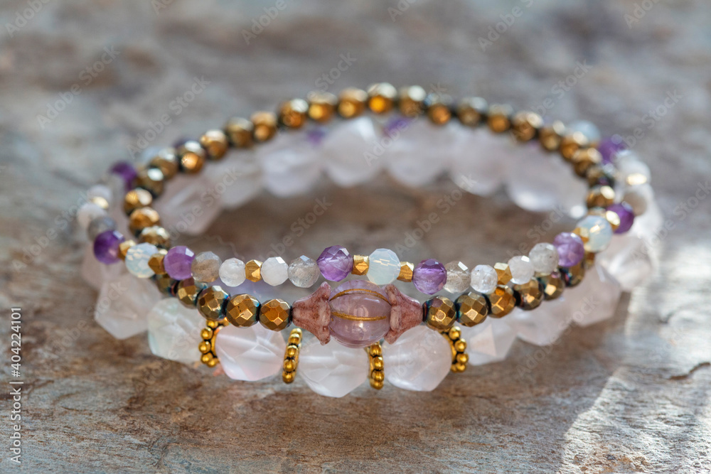 Collection of natural mineral gemstone beads bracletes on natural neutral background Collection of natural mineral gemstone beads bracletes on natural neutral background