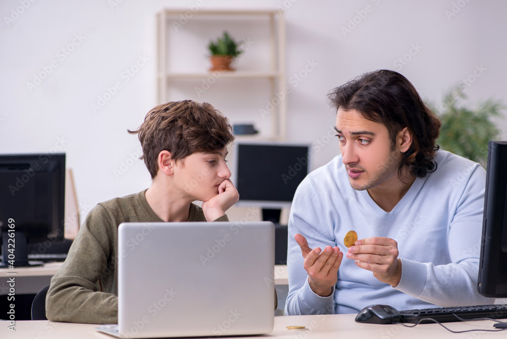Father and son in criptocurrency concept Father and son in criptocurrency concept
