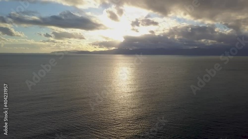 horizon on the shoreline of cagliari (calamosca) at sunset with clouds and calm sea during winter season.