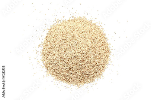 Pile of dry yeast isolated on white background, top view. Active dry yeast on a white background, top view. Dry yeast granules isolated on white background. Dry yeast is used in baked goods. photo