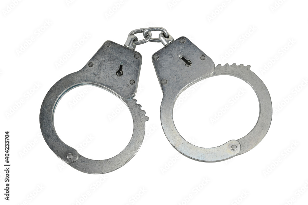 Police handcuffs isolated on white background without shadows. Pair of real metal handcuffs macro close-up high resolution. Police handcuffs isolated on white background without shadows. Pair of real metal handcuffs macro close-up high resolution.