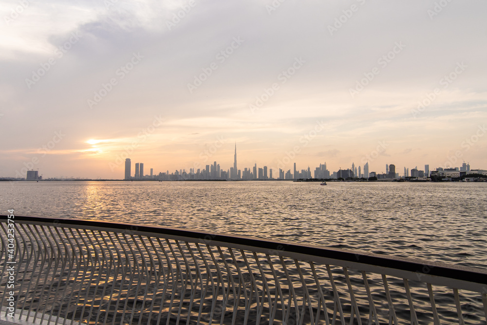 UAE, Dubai - December, 2020: Dubai slyline from Dubai Creek Harbour and Dubai canal to Downtown and Business Bay, United Arab Emirates