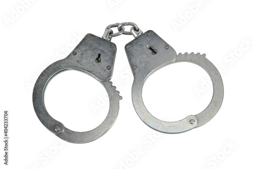 Police handcuffs isolated on white background without shadows. Pair of real metal handcuffs macro close-up high resolution.