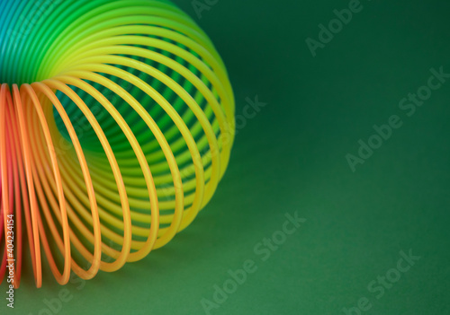 Plastic  Magic Spring rainbow toy in colourful background with copy space for your own text, photography
