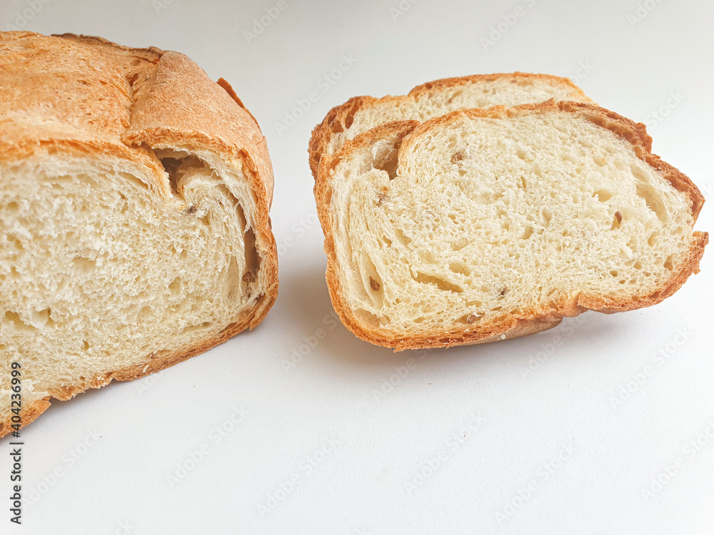 loaf of bread.  Closeup freshly baked homemade traditional bread on white background. Concept - Cooking at Home. Sliced fresh bread 