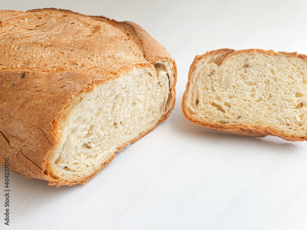 loaf of bread. Closeup freshly baked homemade traditional bread on white background. Concept - Cooking at Home. Sliced fresh bread loaf of bread. Closeup freshly baked homemade traditional bread on white background. Concept - Cooking at Home. Sliced fresh bread