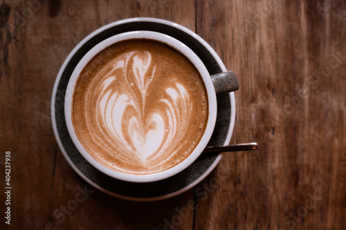 Cup of coffee on the wooden table. Cafe