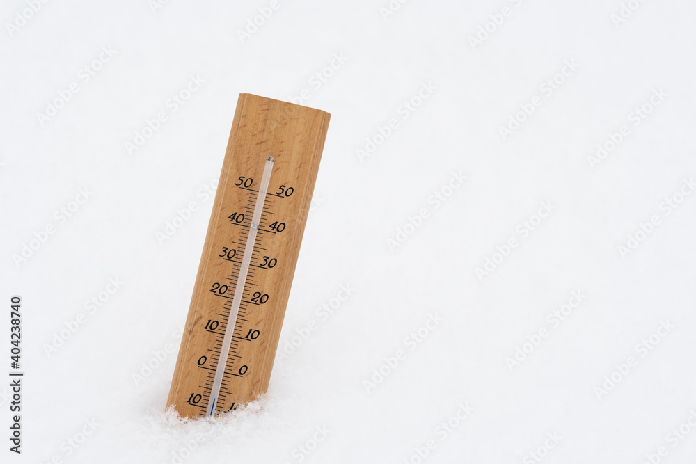 Thermometer on snow showing low temperature Thermometer on snow showing low temperature