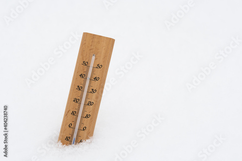 Thermometer on snow showing low temperature