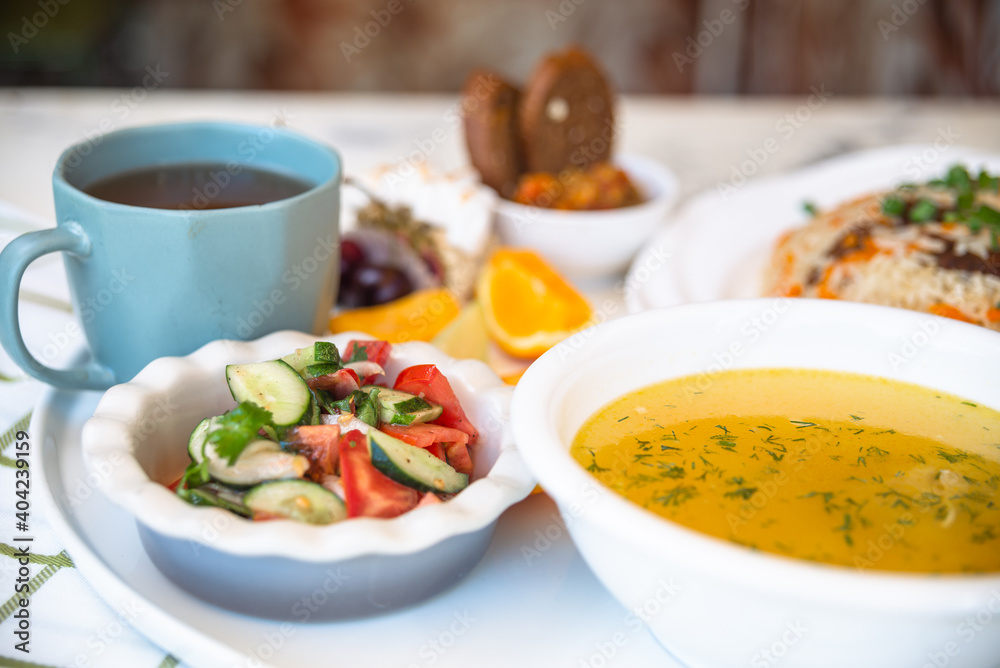 Business lunch in a cafe. set of soup and pilaf Business lunch in a cafe. set of soup and pilaf