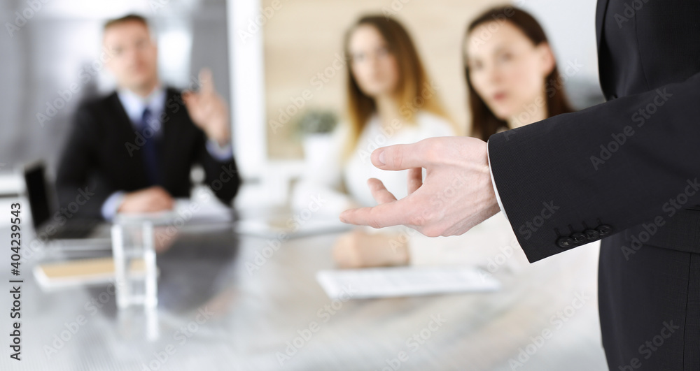 Business presentation. Unknown businessman giving a speech to colleagues or partners at corporate conference. Meeting concept Business presentation. Unknown businessman giving a speech to colleagues or partners at corporate conference. Meeting concept