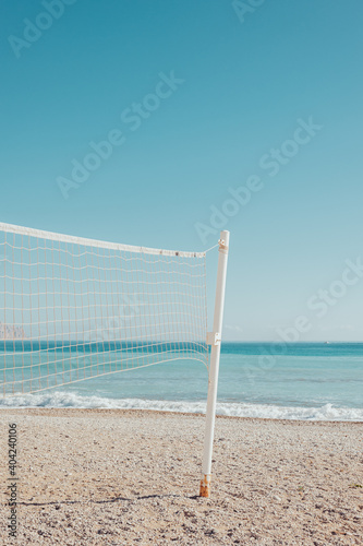 White volleyball net in a turquoise beach in Mediterranean sea