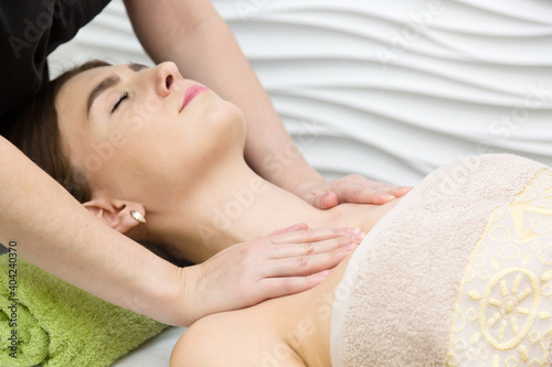 Therapeutic breast and shoulder massage a young woman.