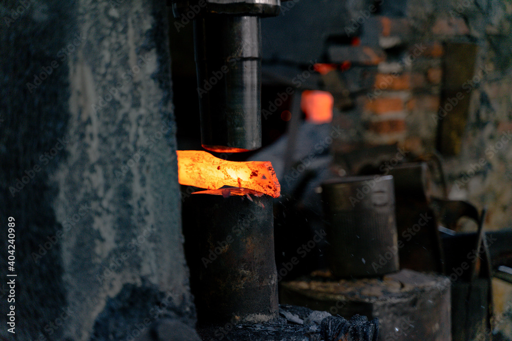 The blacksmith is forging very hot iron to make various tools. The blacksmith is forging very hot iron to make various tools.