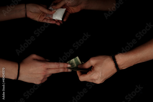 Hand of addict woman with buying dose of cocaine from drug dealer. Narcotics concept. Horizontal close-up macro shot. High quality image.