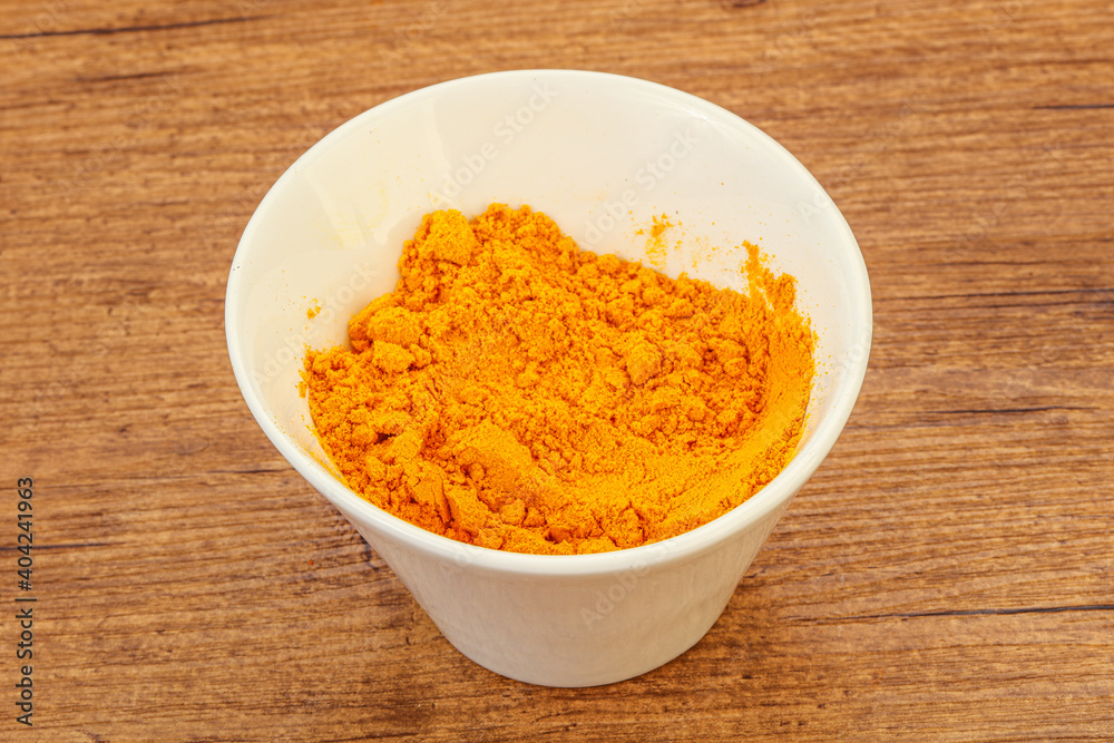 Tumeric powder in the bowl Tumeric powder in the bowl