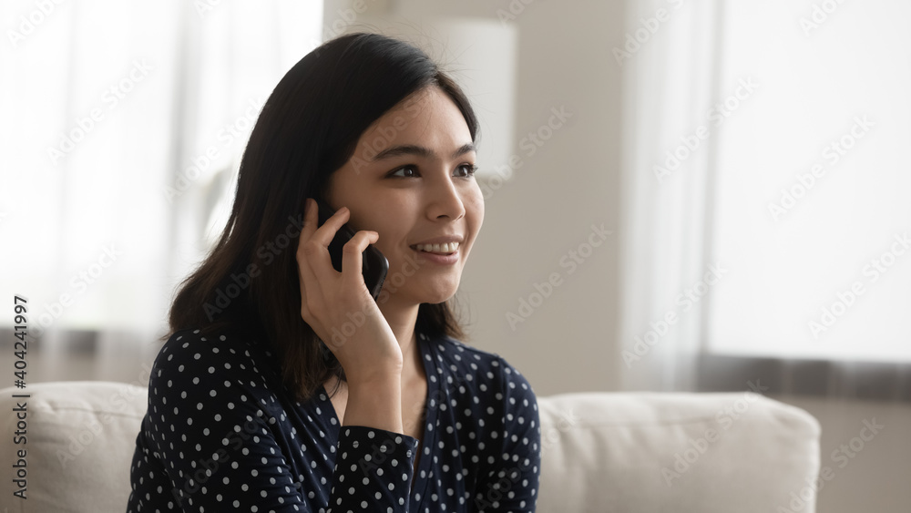 Head shot smiling pretty millennial vietnamese asian woman holding mobile phone talk with friend, enjoying pleasant distant communication conversation, addicted to modern technology people concept. Head shot smiling pretty millennial vietnamese asian woman holding mobile phone talk with friend, enjoying pleasant distant communication conversation, addicted to modern technology people concept.