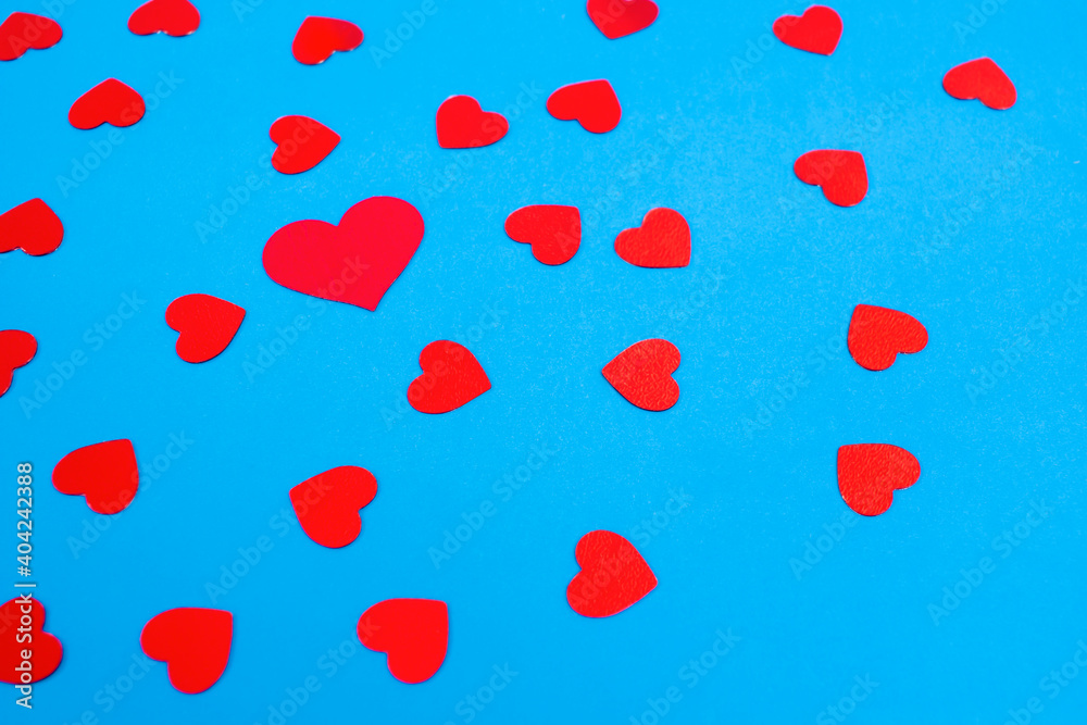Red hearts on a blue background. Contrast pictures.