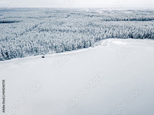 Frozen Lake with Snow Covered Natural Park in Background