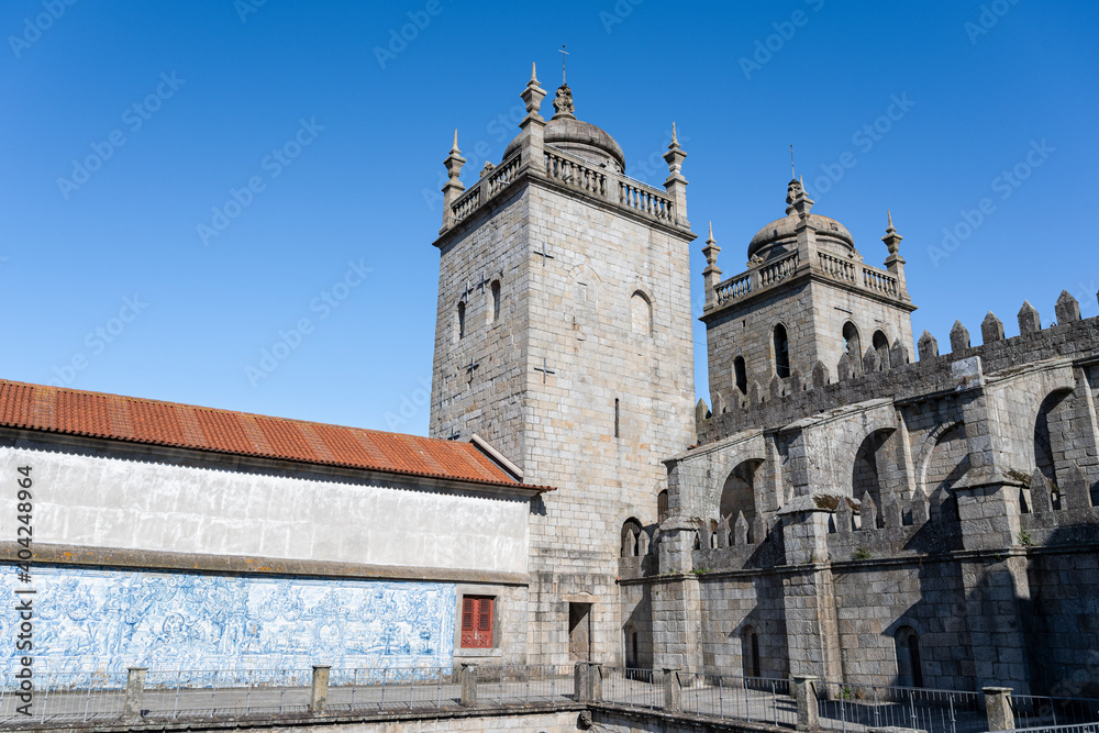 Porto cathedral seen from the inner courtyard. Building made of stone Blue sky. Porto cathedral seen from the inner courtyard. Building made of stone Blue sky.