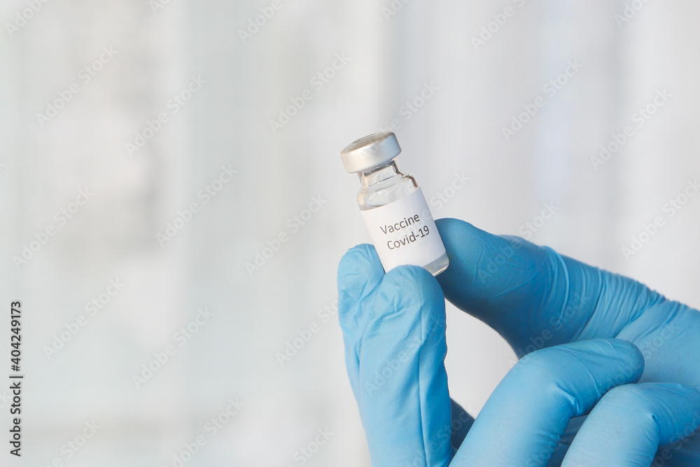 doctor hand in gloves holding coronavirus vaccine, close up doctor hand in gloves holding coronavirus vaccine, close up