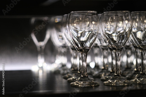 close up many empty wineglass in dark